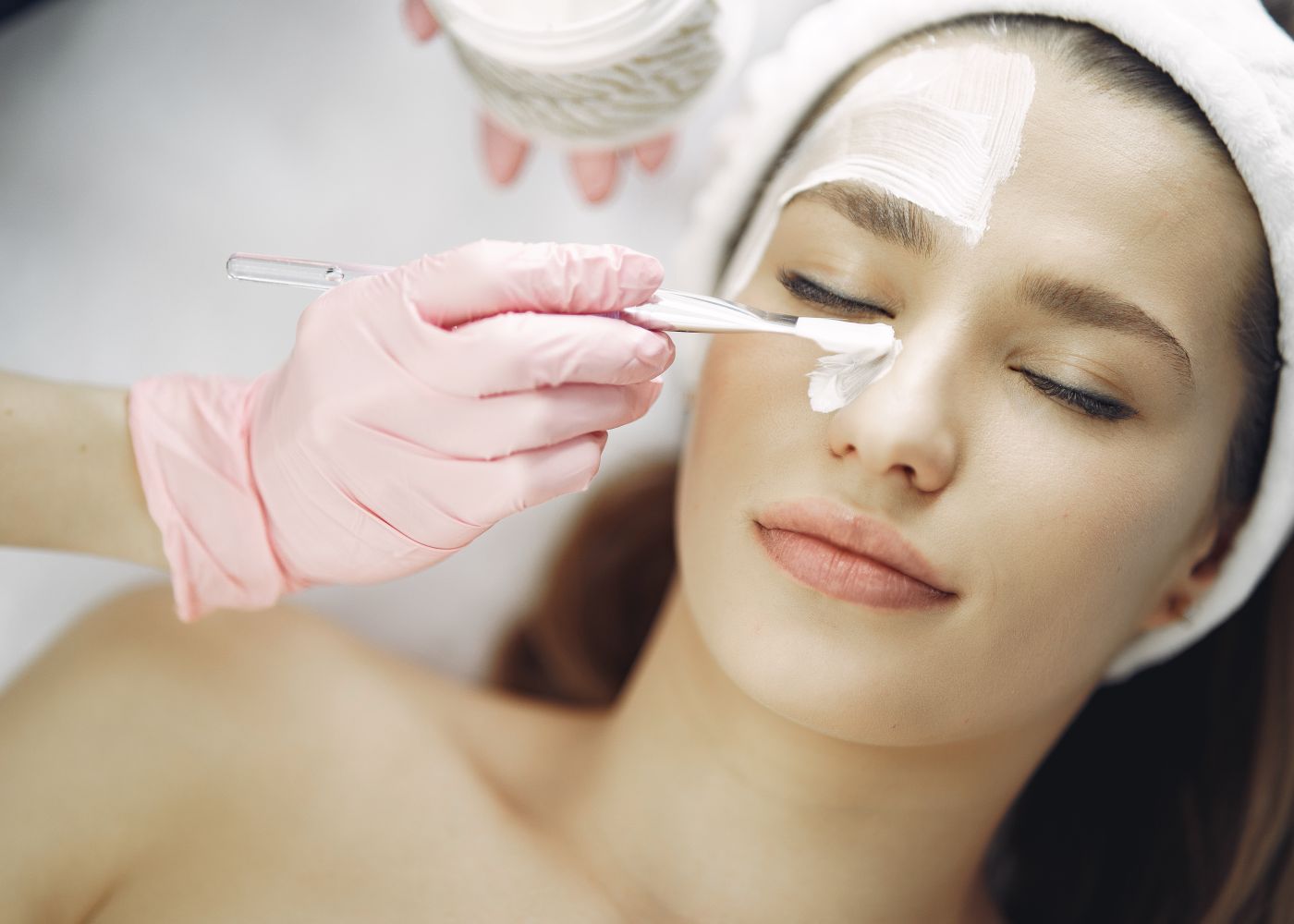 A woman receiving a gentle facial treatment